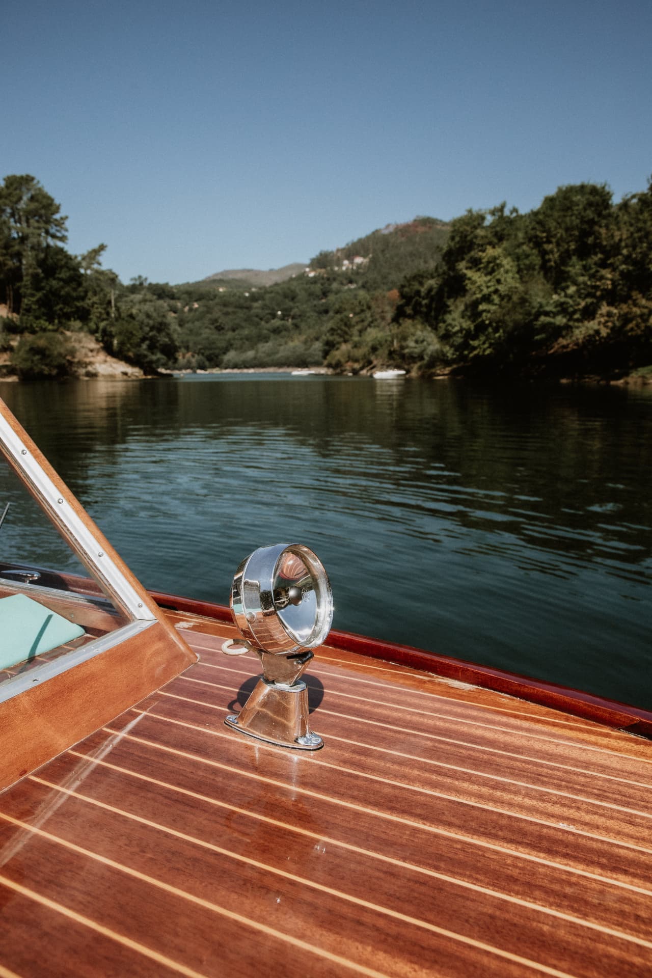 Chrome navigation lamp on the varnished foredeck